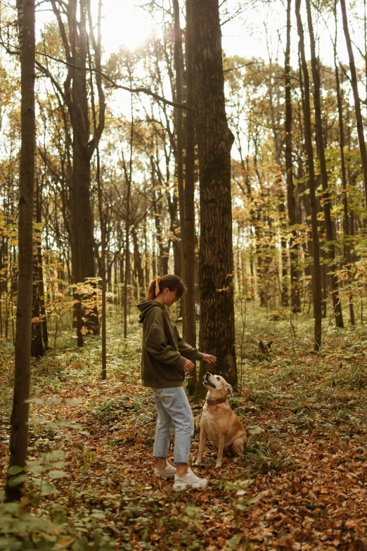 a lady and her dog in the woods
