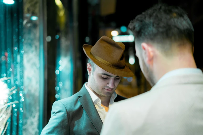 two men are dressed up in hats and reading