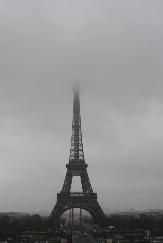 a view of the eiffel tower from below in heavy rain