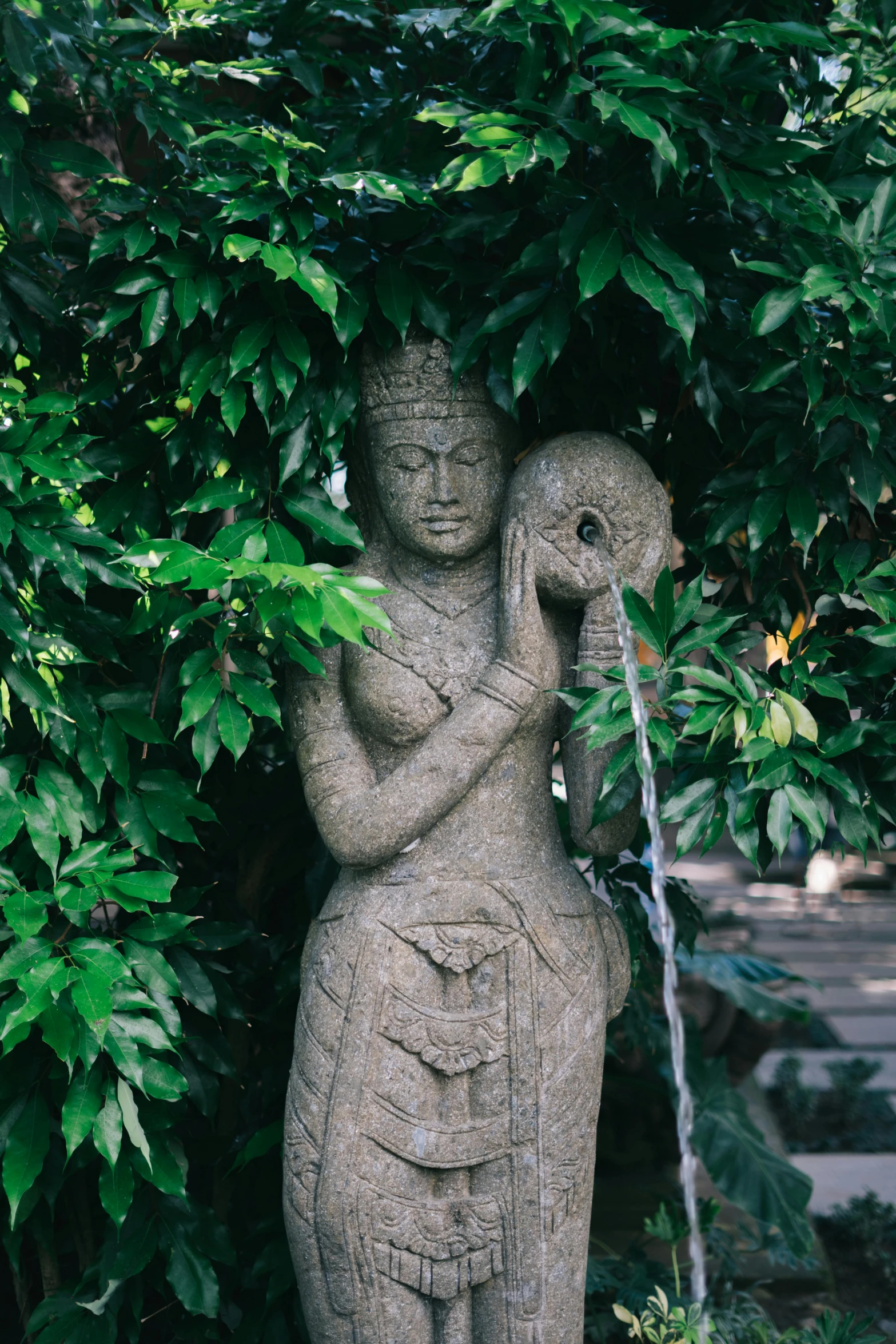 a statue of a woman with birds around her neck