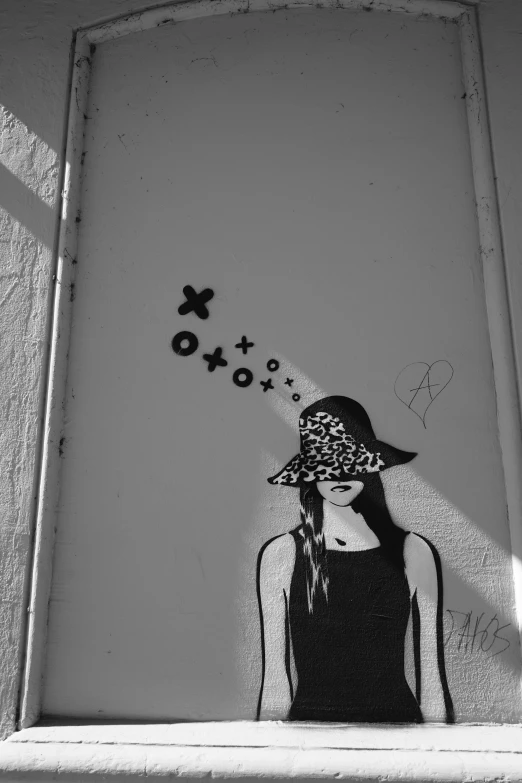 a black and white image with many symbols spray painted on the wall