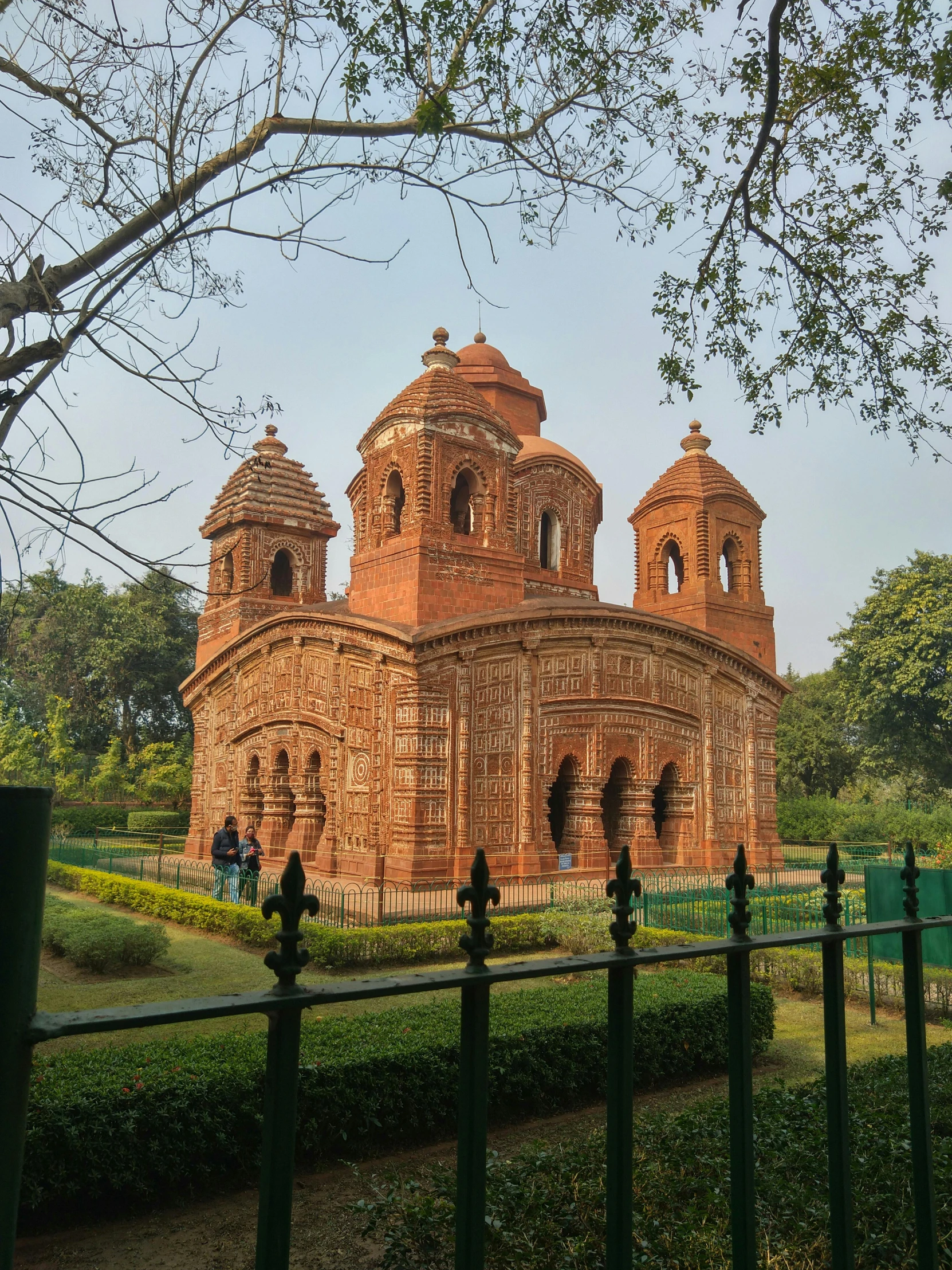 an old brick church sits on a hillside