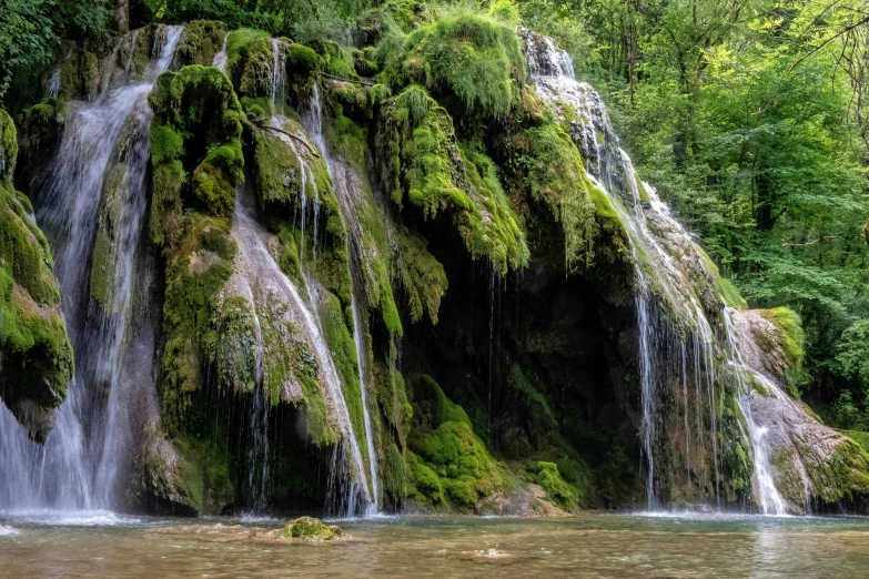 a man standing on the edge of a waterfall