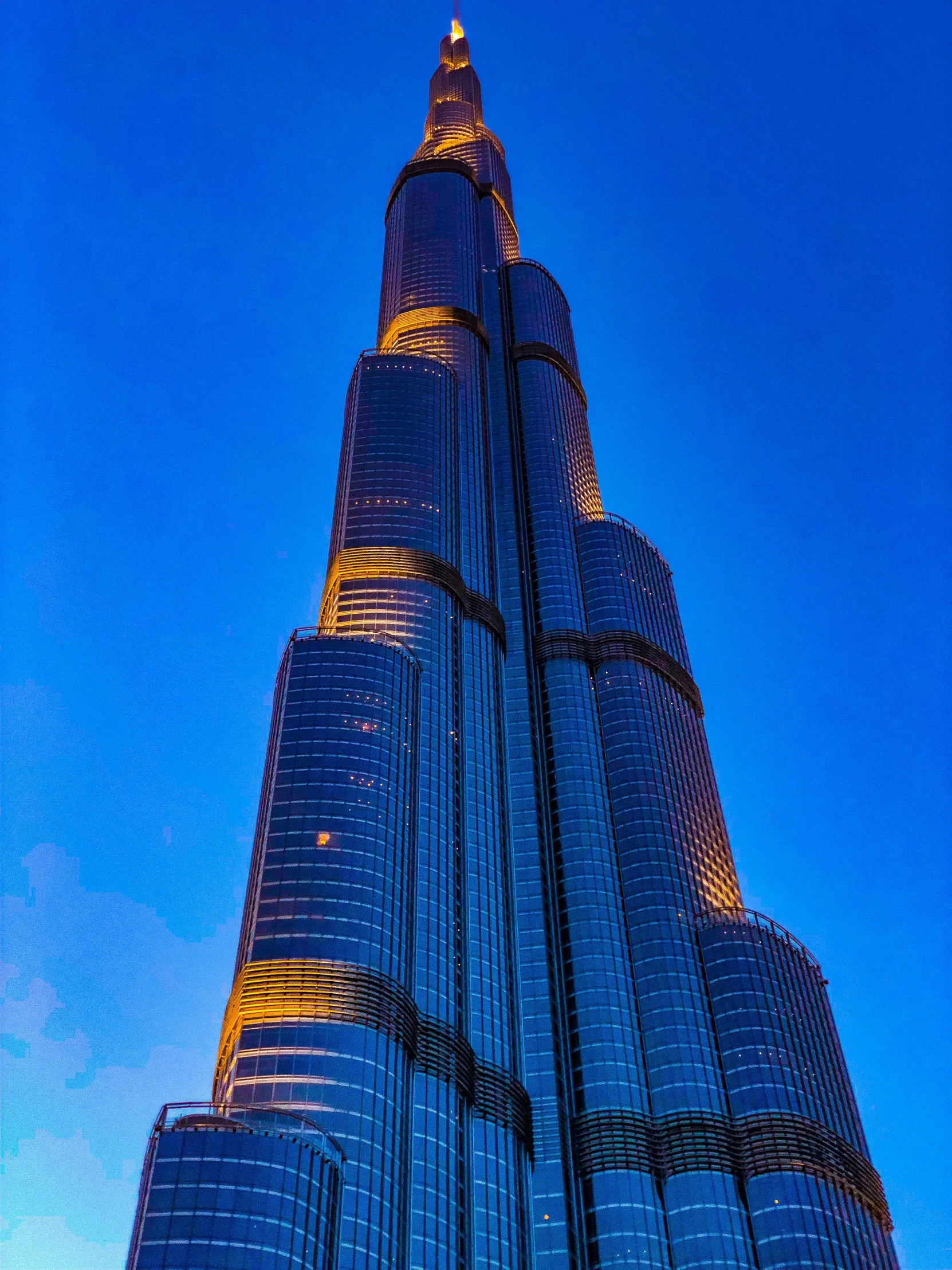 the top of the burjt in the middle of blue skies