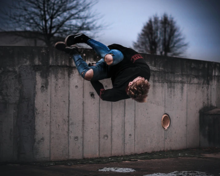 a man riding a skateboard on top of cement