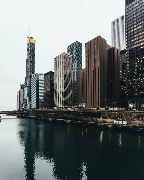 boats on a body of water in front of tall buildings