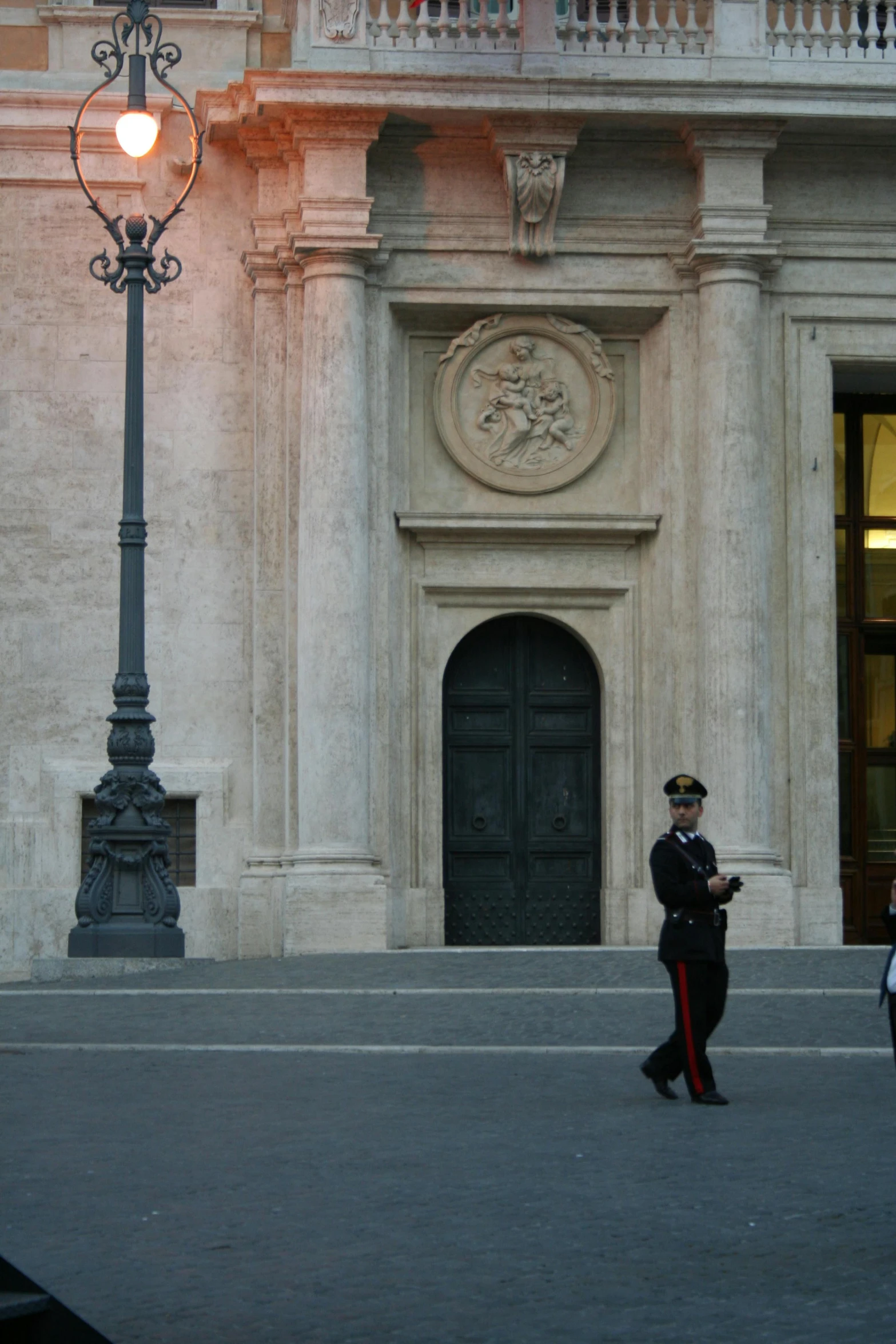 a man walking by a light in a street