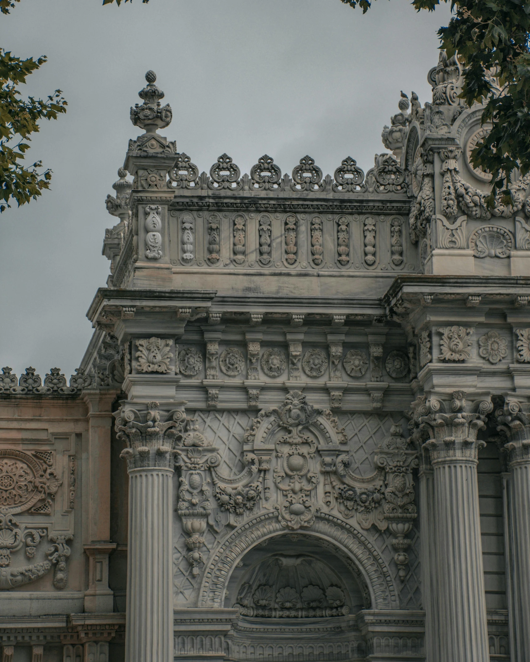 architectural details on an old stone building under grey skies