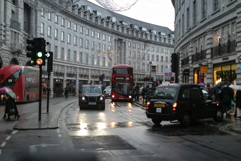 cars are driving down the street in the city