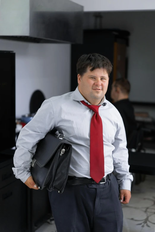 a man wearing a shirt and tie with his hands in his pockets