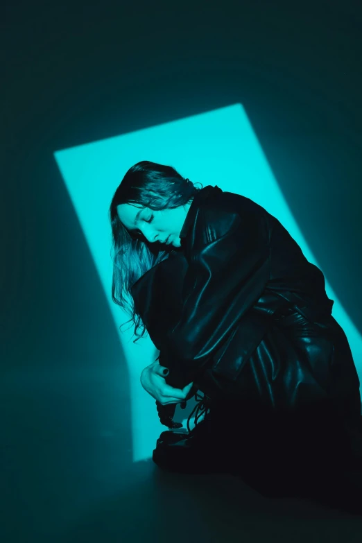 a woman with a black jacket and heels is crouching down and holding her hand to her knees