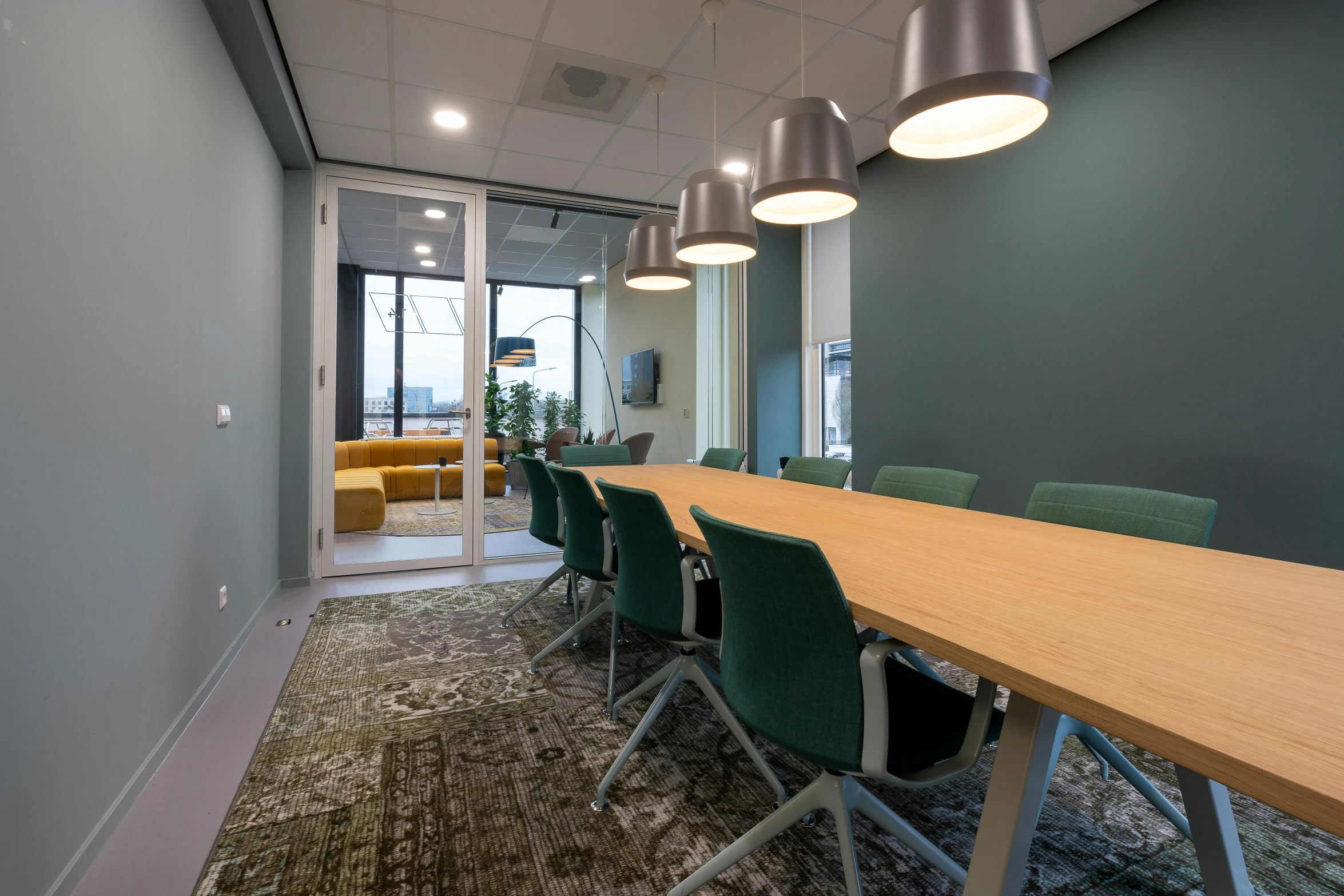 an empty conference room with wood and metal chairs