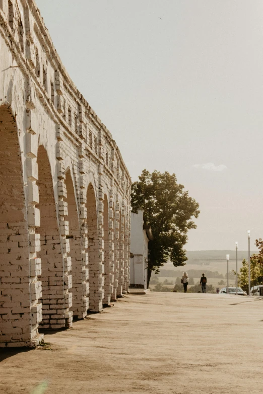 several people walk down an alley between buildings