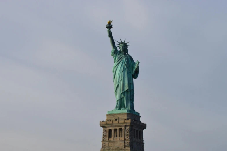 the statue of liberty stands high on a hill