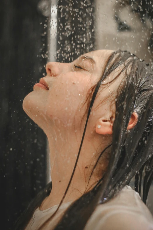 a woman wearing rain gear is looking at the rain