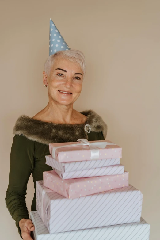 the older woman is holding several gift boxes