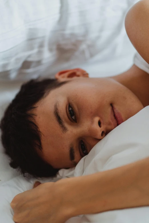 a boy is lying down in his bed