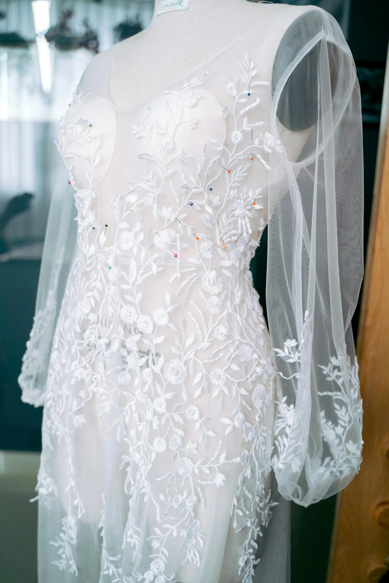 a womans wedding dress sits on display