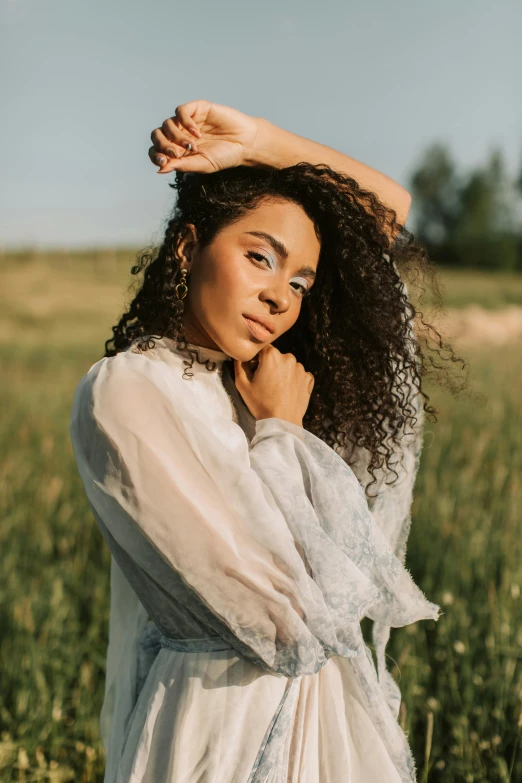 the woman is posing with her hair in her hands