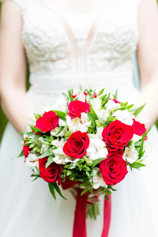 a bridal bouquet sits on top of the brides arm