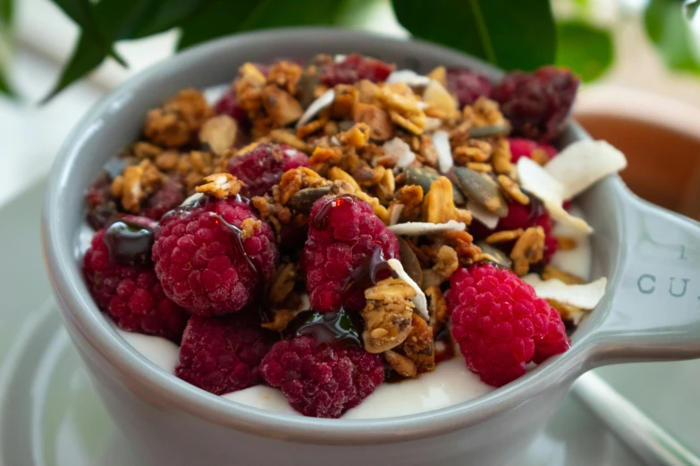 the yogurt is being drizzled over berries