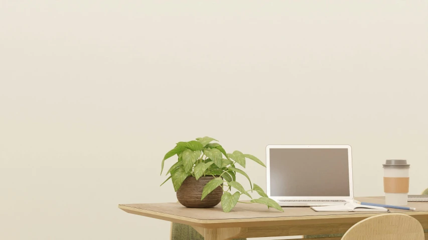 a laptop sitting on a small desk next to a plant