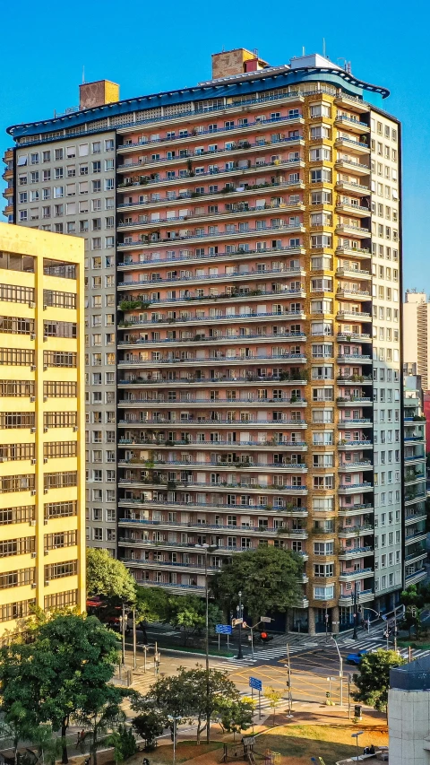 an apartment building sits near some other high rise buildings