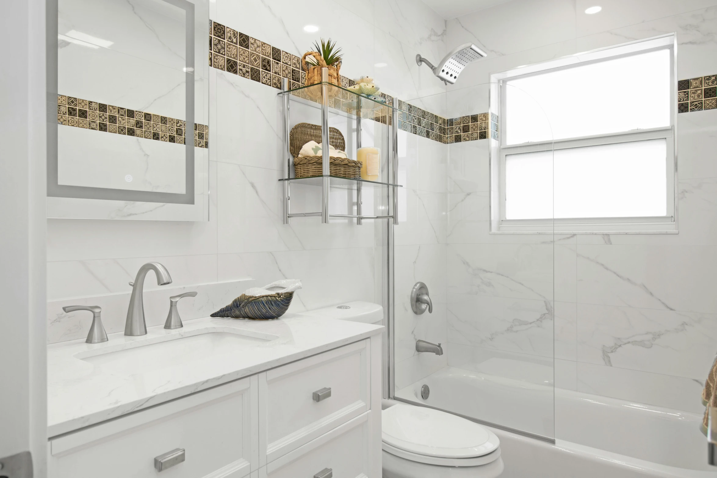 this bathroom features white marble walls, a tub, and a walk in shower