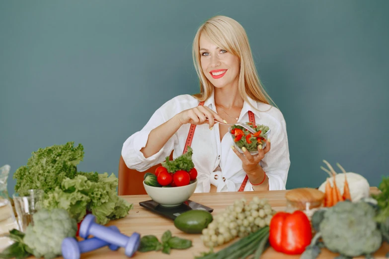 a woman holding a basket full of vegetables