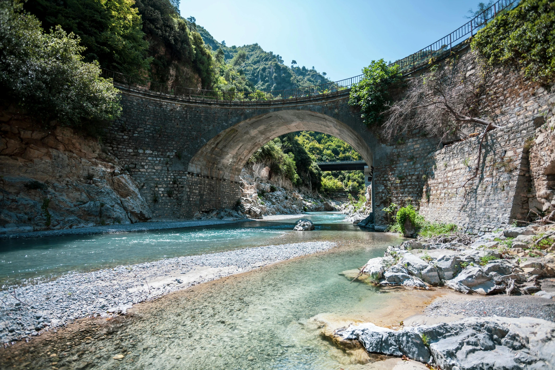 an image of an old bridge over a river