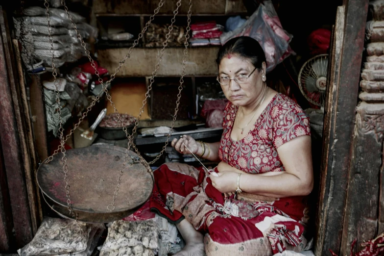 a woman is making soing from material she is wearing