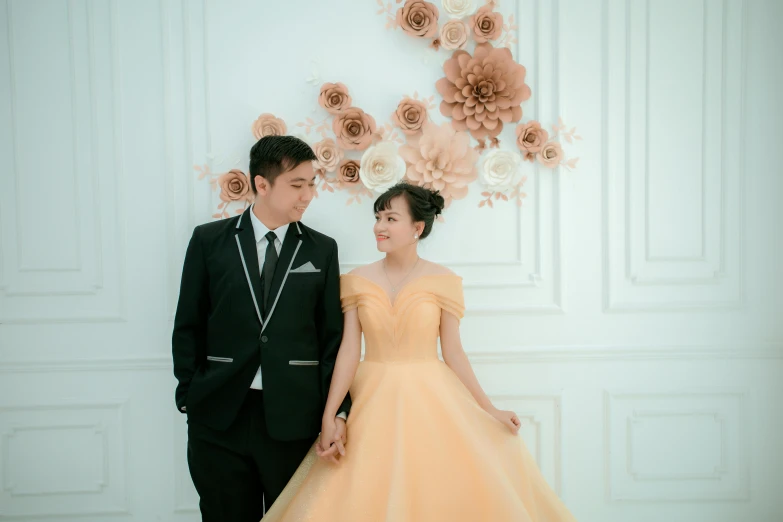 a man and woman are posing for a po in their wedding outfits