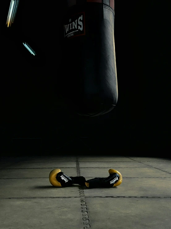 a pair of boxing gloves rests on the floor