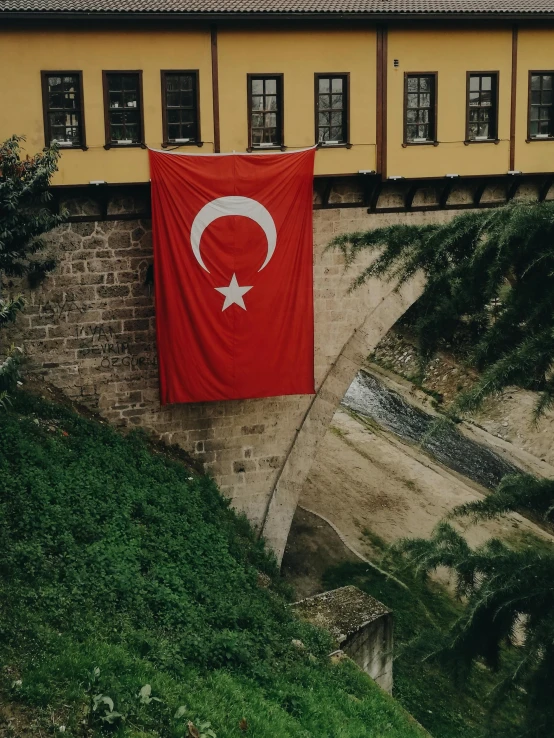 a red turkish flag hanging from a wall