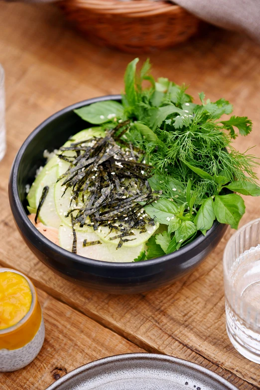 a bowl filled with food sitting on top of a wooden table