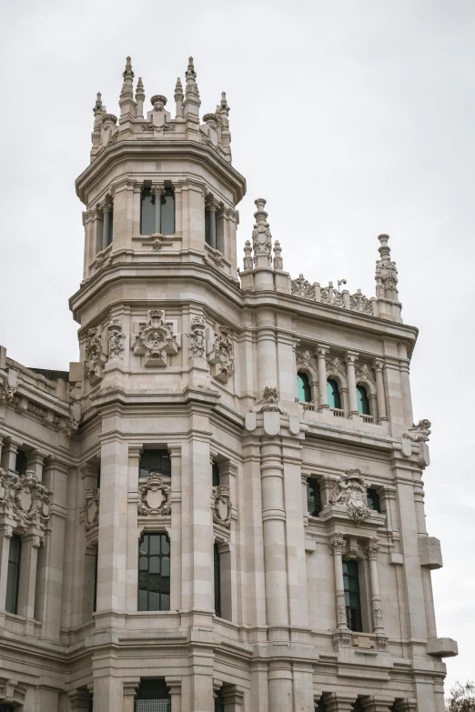 an architecturally elaborate stone building has two clock on the tower