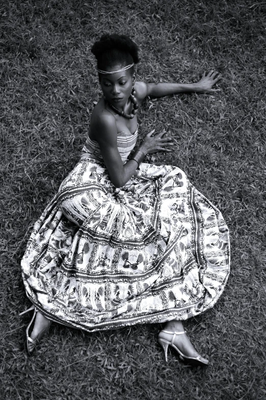 a woman in a long dress on the ground