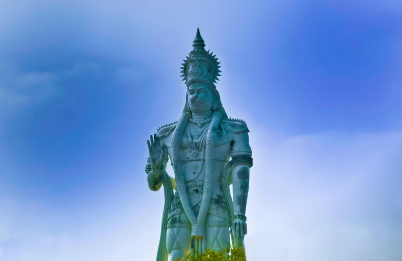 there is a statue in front of a blue sky