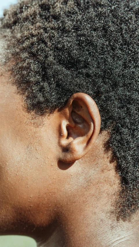 an ear with a single piece of hair on top