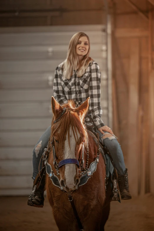 woman smiling while riding on the back of a horse