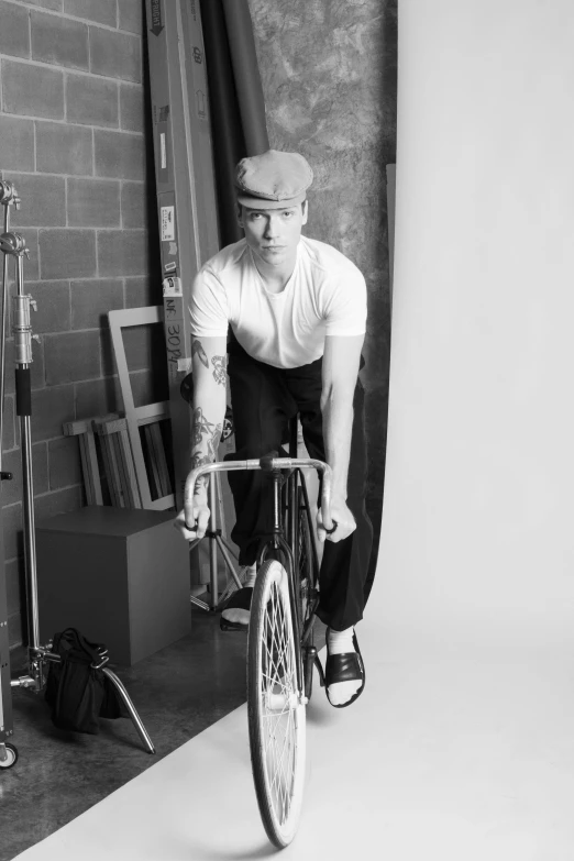 a black and white po shows a male cyclist in the studio