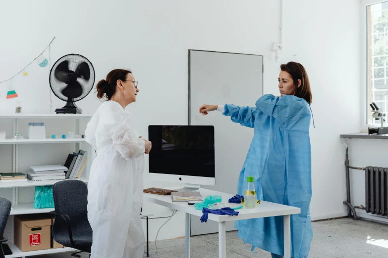 two women are dressed up to look like they're in lab coats