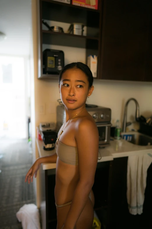 a woman in a  poses in the kitchen