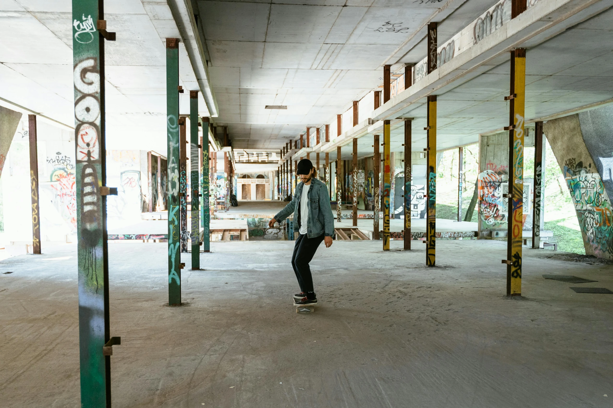 a boy is skateboarding in a dirty building