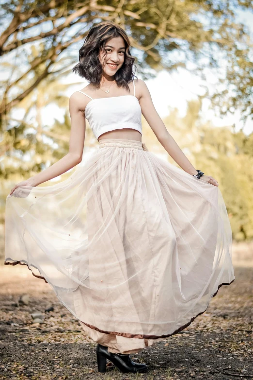 a woman in a white top and a tan skirt