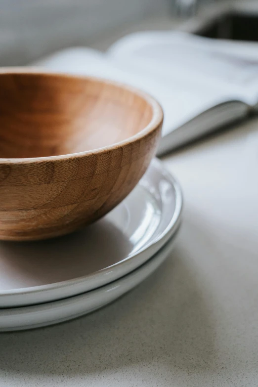 a close up of a wooden bowl on a plate