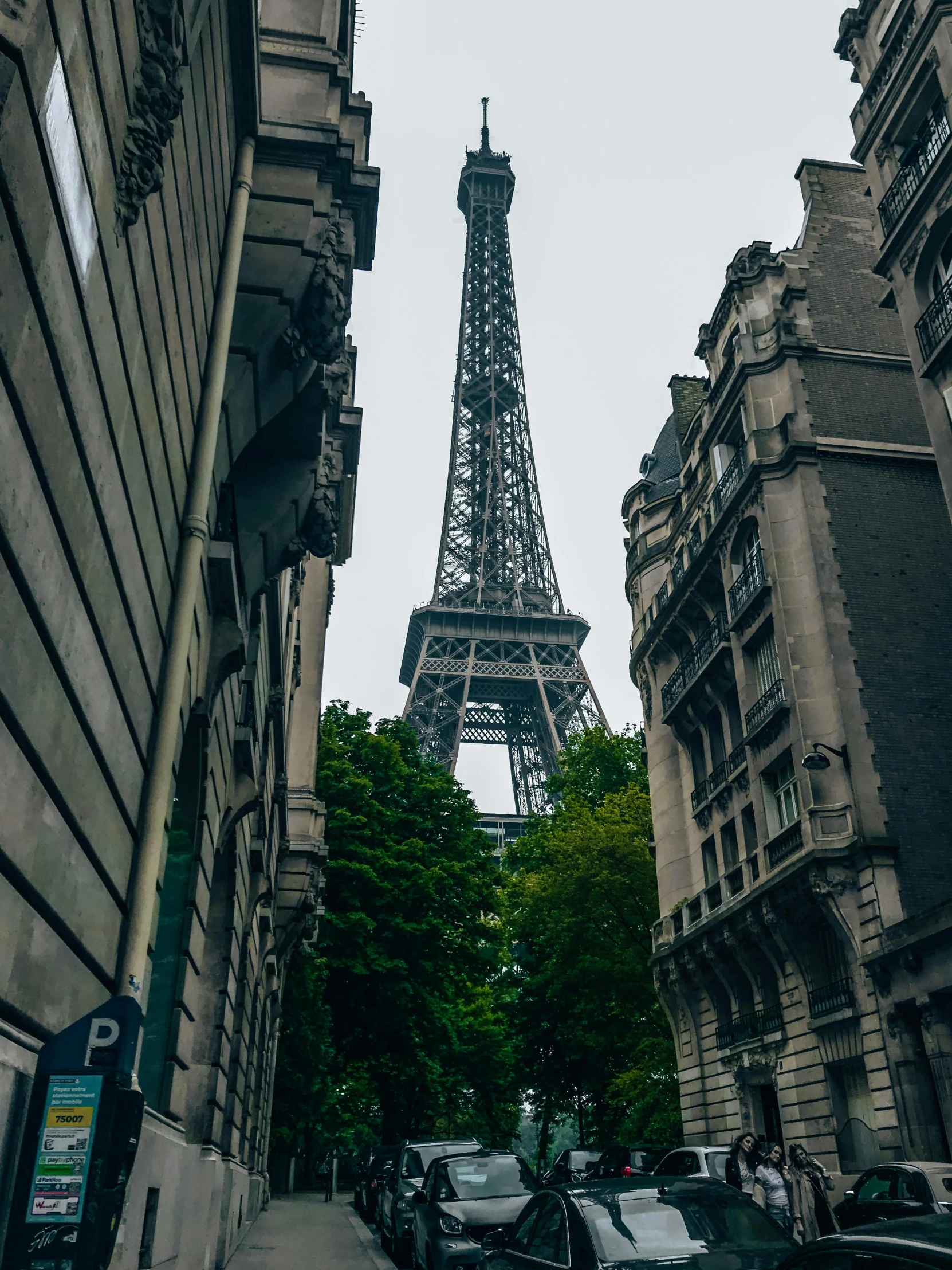 the eiffel tower is towering over many tall buildings