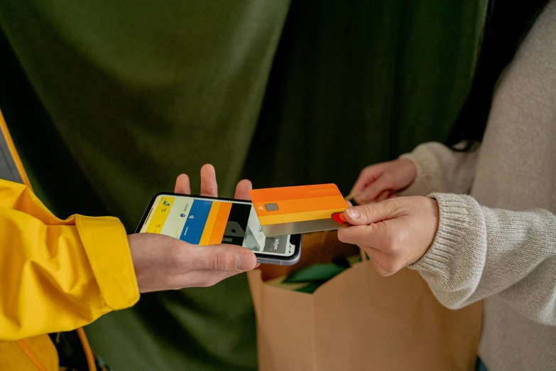 the person holds a colorful case made from recycled material