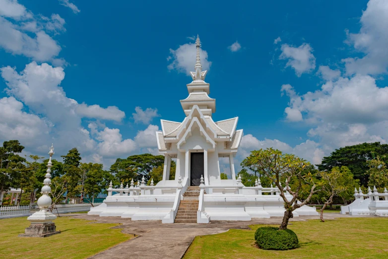 a white gazebo with stairs to the entrance