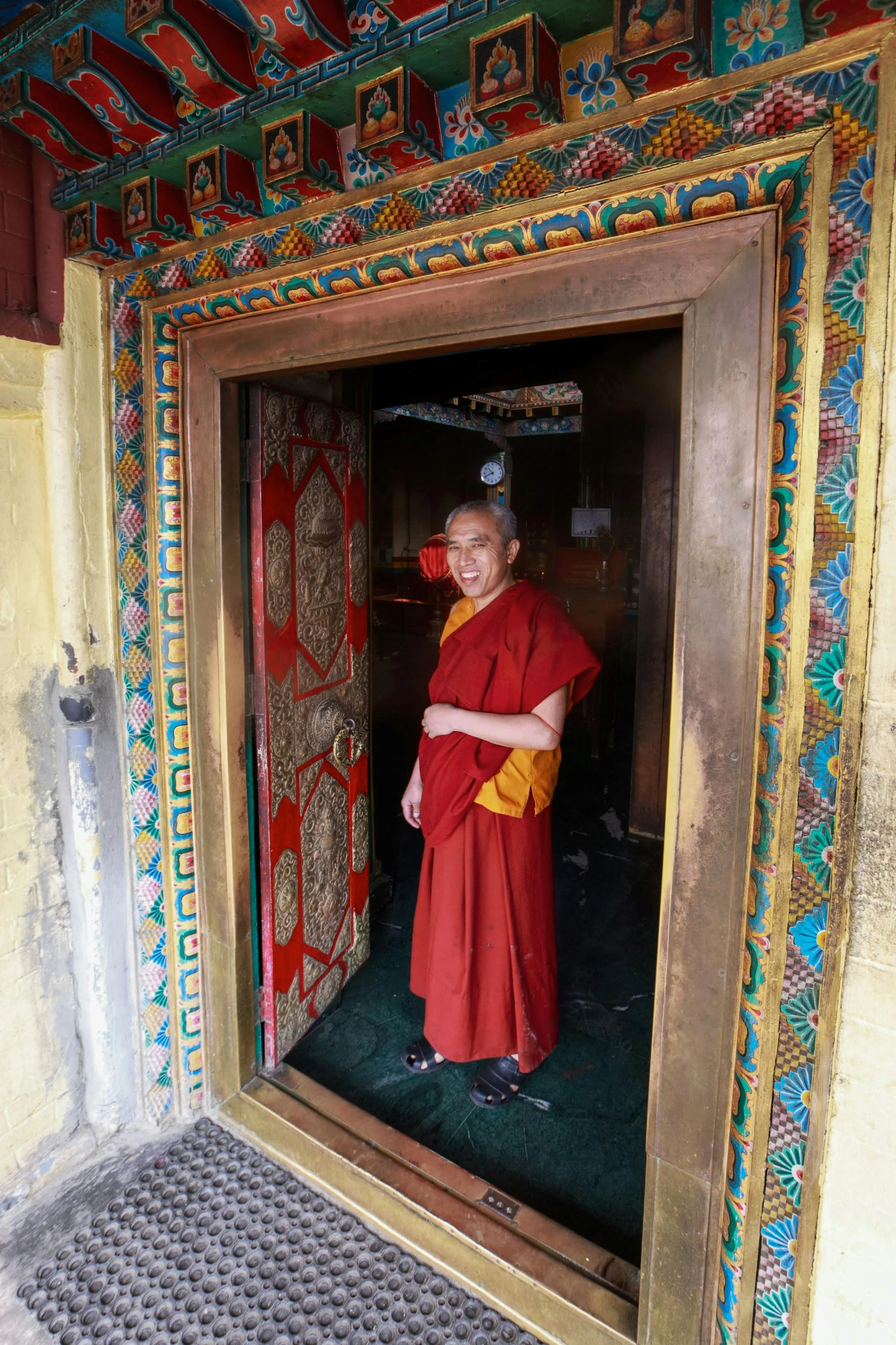 a monk in an open doorway of a building